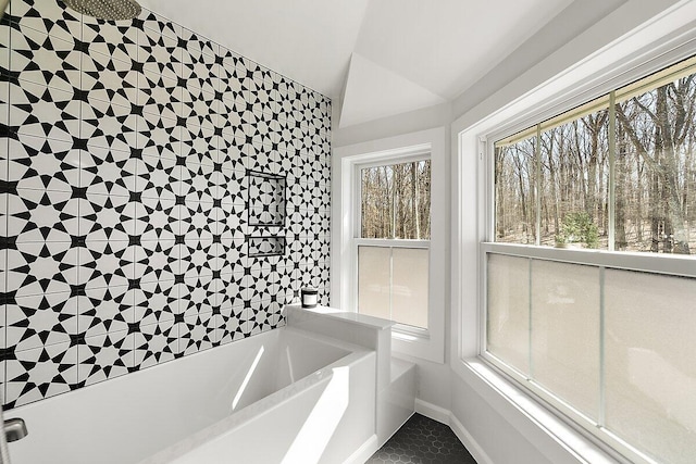 8282 W Harrison Rd, Mears, MI 49436 - full bathroom with a garden tub, vaulted ceiling, baseboards, tile patterned flooring, and tiled shower