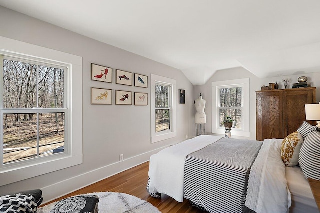 8282 W Harrison Rd, Mears, MI 49436 - bedroom with wood finished floors, lofted ceiling, and baseboards