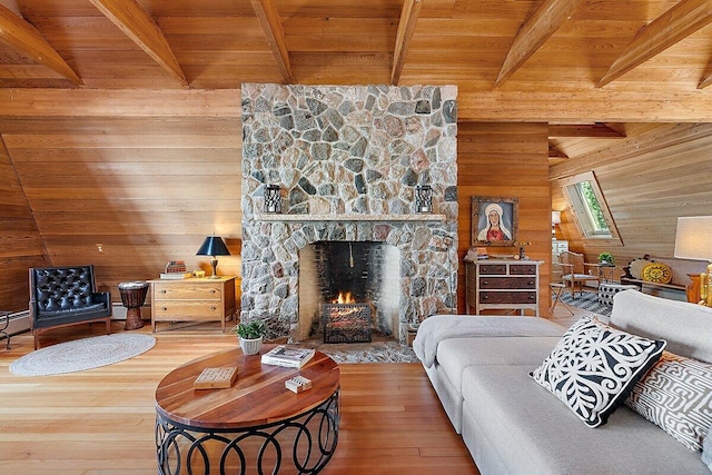 8282 W Harrison Rd, Mears, MI 49436 - living area with beamed ceiling, wooden walls, a fireplace, wooden ceiling, and wood finished floors