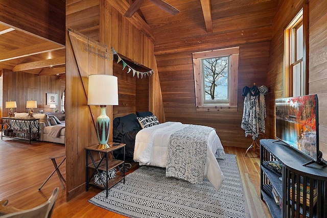 8282 W Harrison Rd, Mears, MI 49436 - bedroom with wood walls, wooden ceiling, and wood finished floors