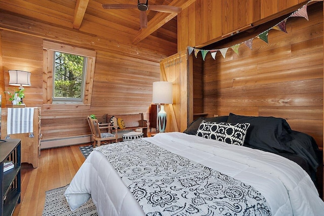 8282 W Harrison Rd, Mears, MI 49436 - bedroom with wooden walls, wood ceiling, a baseboard radiator, and wood-type flooring