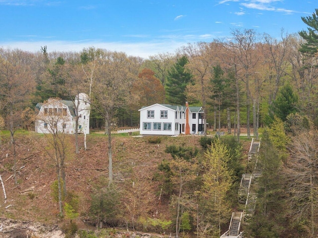 8282 W Harrison Rd, Mears, MI 49436 - aerial view of property and surrounding area with a heavily wooded area