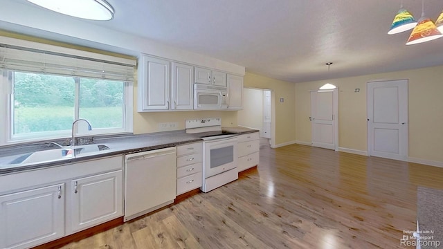 4200 Chapman Rd, Stockbridge, MI 49285 - kitchen with white appliances, a sink, light wood finished floors, and white cabinetry