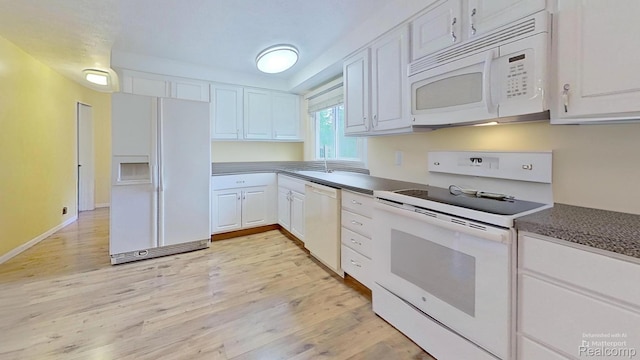 4200 Chapman Rd, Stockbridge, MI 49285 - kitchen featuring white appliances, white cabinets, light wood-style floors, and dark countertops