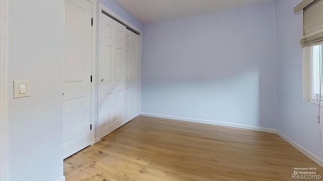 4200 Chapman Rd, Stockbridge, MI 49285 - unfurnished bedroom with baseboards and light wood-style flooring