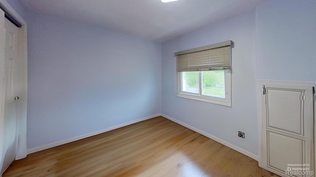 4200 Chapman Rd, Stockbridge, MI 49285 - unfurnished bedroom with light wood-type flooring and baseboards