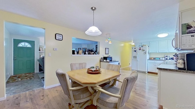 4200 Chapman Rd, Stockbridge, MI 49285 - dining room featuring light wood-style floors and baseboards