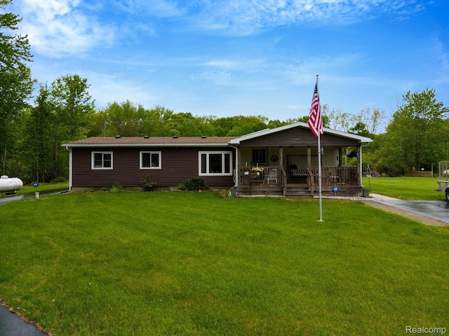 4200 Chapman Rd, Stockbridge, MI 49285 - view of front of home featuring a porch and a front yard