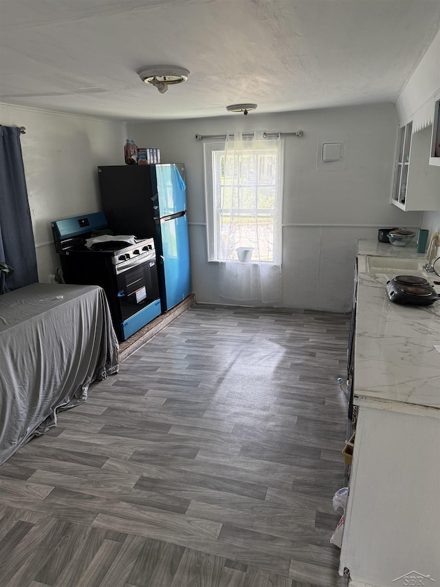 1541 Emily St, Saginaw, MI 48601 - kitchen featuring range, dark wood-style floors, and white cabinets