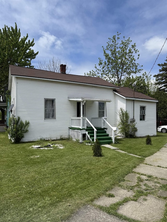 1541 Emily St, Saginaw, MI 48601 - view of front of home featuring a chimney and a front yard