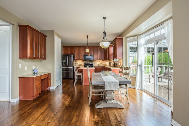 58799 Carriage Ln, South Lyon, MI 48178 - dining area featuring dark wood-style floors and baseboards