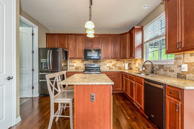 58799 Carriage Ln, South Lyon, MI 48178 - kitchen with stainless steel appliances, a sink, dark wood-style flooring, and a center island