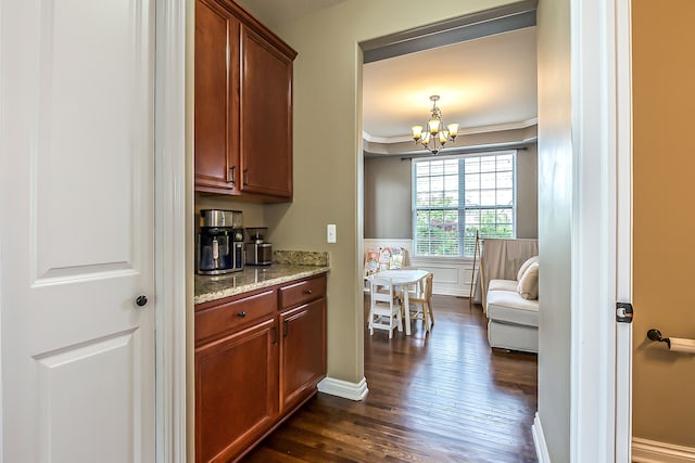 58799 Carriage Ln, South Lyon, MI 48178 - bar featuring dark wood-style flooring, a chandelier, and crown molding
