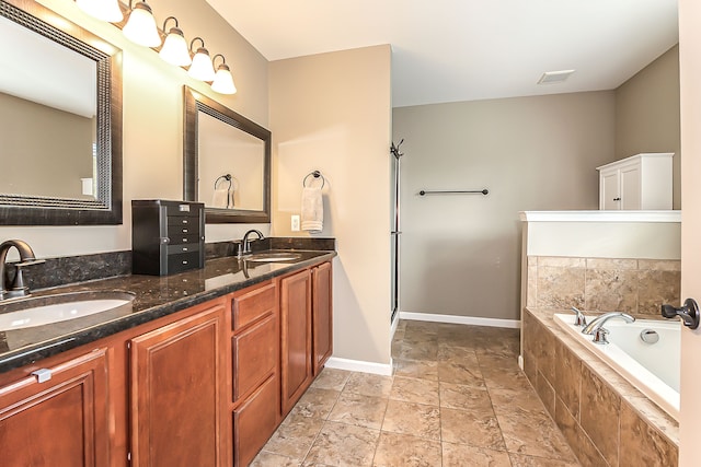 58799 Carriage Ln, South Lyon, MI 48178 - full bath with stone tile floors, a bath, double vanity, and baseboards
