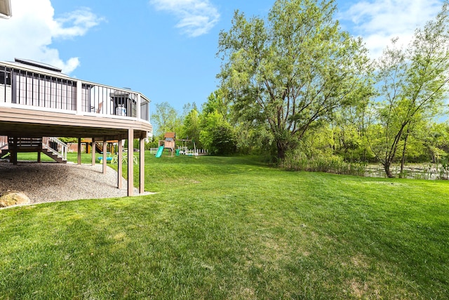 58799 Carriage Ln, South Lyon, MI 48178 - view of grassy yard featuring a playground and a deck