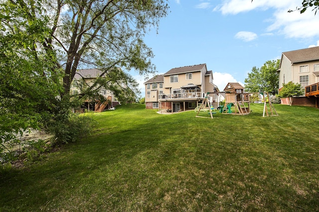 58799 Carriage Ln, South Lyon, MI 48178 - view of grassy yard featuring a playground and a deck