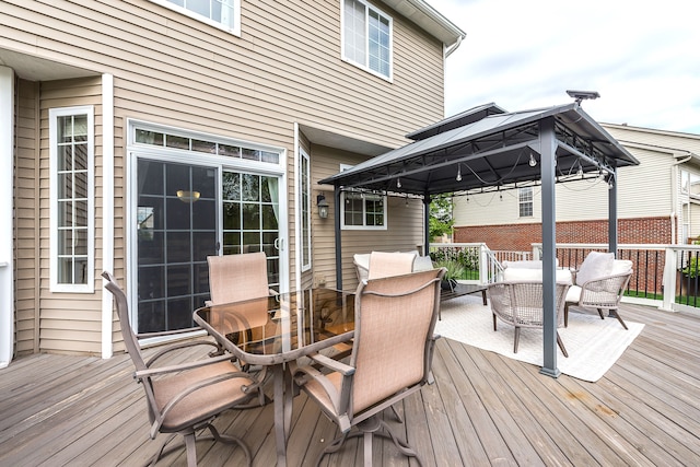 58799 Carriage Ln, South Lyon, MI 48178 - wooden deck featuring a gazebo and outdoor dining area