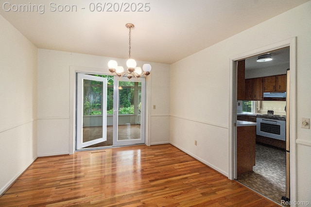 8276 Appleway Dr, Grand Blanc, MI 48439 - unfurnished room with wood finished floors and a chandelier