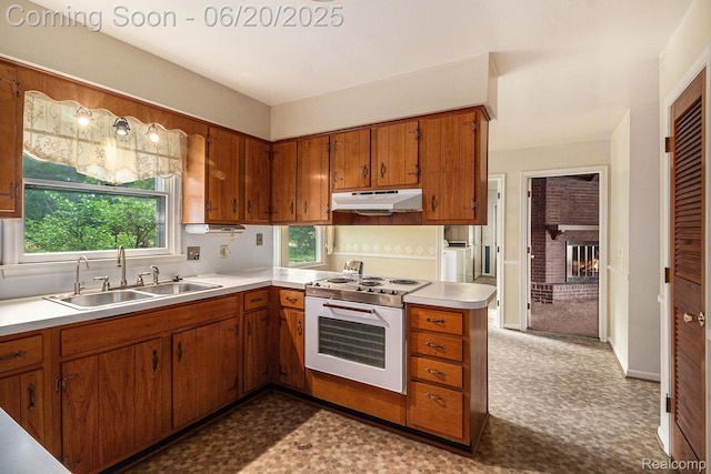 8276 Appleway Dr, Grand Blanc, MI 48439 - kitchen with white electric range oven, under cabinet range hood, brown cabinetry, light countertops, and tile patterned floors