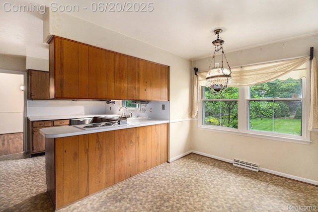 8276 Appleway Dr, Grand Blanc, MI 48439 - kitchen featuring brown cabinetry, stainless steel dishwasher, a peninsula, and light countertops