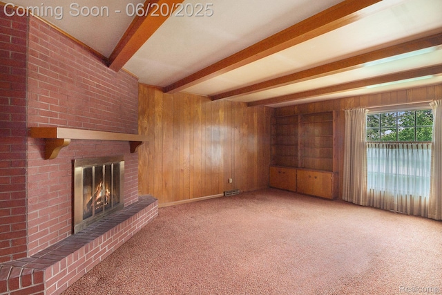 8276 Appleway Dr, Grand Blanc, MI 48439 - unfurnished living room featuring wooden walls, beamed ceiling, a fireplace, and carpet floors