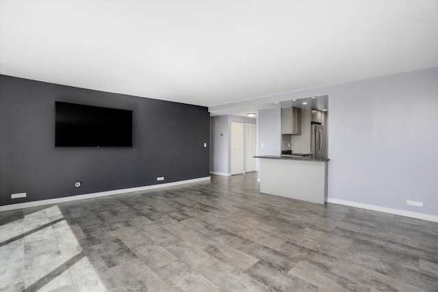 1300 E Lafayette St Unit 305, Detroit, MI 48207 - unfurnished living room with baseboards and wood finished floors