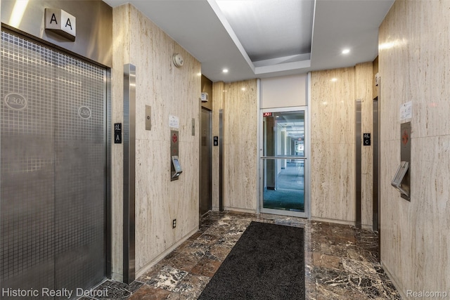 1300 E Lafayette St Unit 305, Detroit, MI 48207 - hall featuring elevator, a tray ceiling, and recessed lighting