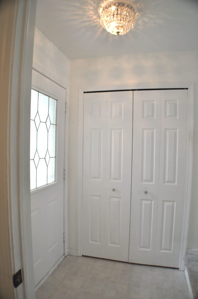 4439 Hunters Cir W, Canton, MI 48188 - doorway to outside featuring baseboards and a chandelier