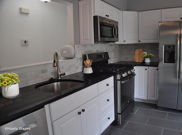 4439 Hunters Cir W, Canton, MI 48188 - kitchen with stainless steel appliances, a sink, dark tile patterned floors, decorative backsplash, and white cabinets