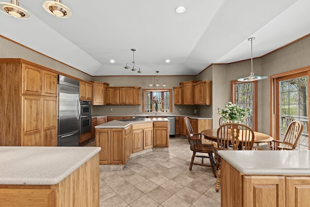 9997 Applegate Ln, Brighton, MI 48114 - kitchen featuring vaulted ceiling, a center island, appliances with stainless steel finishes, light countertops, and pendant lighting
