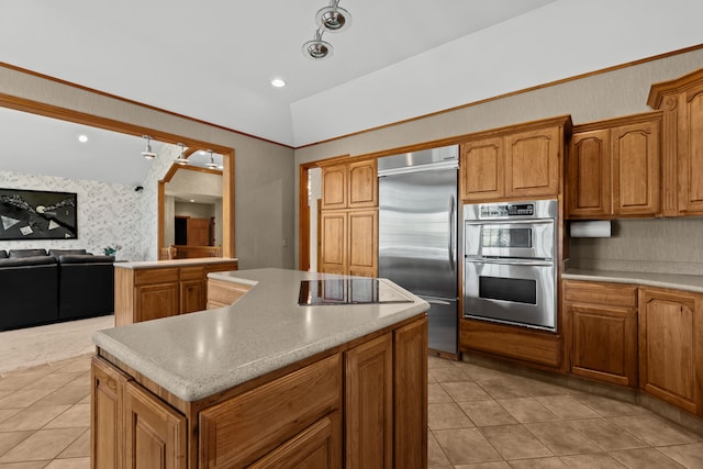 9997 Applegate Ln, Brighton, MI 48114 - kitchen with stainless steel appliances, a kitchen island, light tile patterned flooring, open floor plan, and wallpapered walls