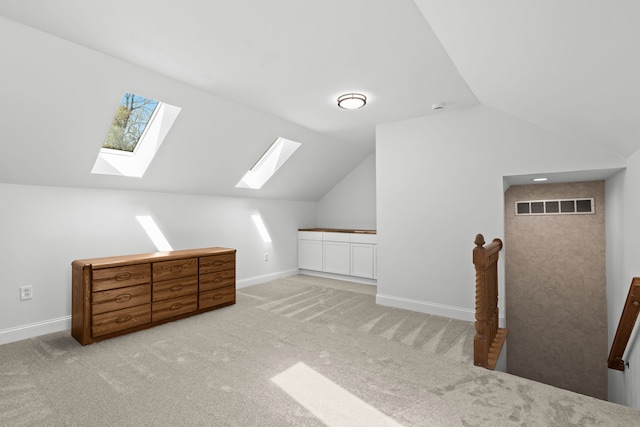 9997 Applegate Ln, Brighton, MI 48114 - bonus room featuring a skylight, lofted ceiling, carpet floors, and baseboards