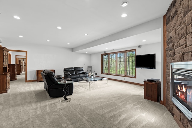 9997 Applegate Ln, Brighton, MI 48114 - living room featuring light colored carpet, a stone fireplace, recessed lighting, and baseboards