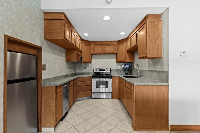 9997 Applegate Ln, Brighton, MI 48114 - kitchen featuring stainless steel appliances, a sink, brown cabinetry, light tile patterned floors, and recessed lighting