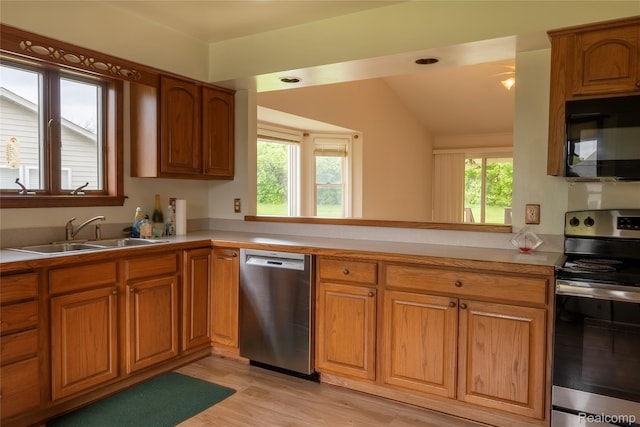 4359 Springbrook Dr, Swartz Creek, MI 48473 - kitchen with appliances with stainless steel finishes, a sink, lofted ceiling, light countertops, and brown cabinets