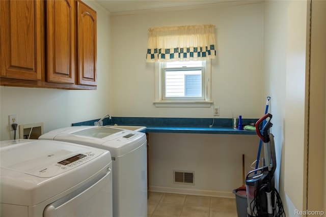 4359 Springbrook Dr, Swartz Creek, MI 48473 - washroom featuring cabinet space, washing machine and clothes dryer, and light tile patterned flooring