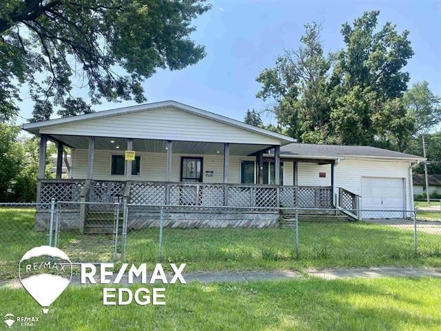 2906 Nathan Ave, Flint, MI 48506 - view of front of home with a porch, a garage, and driveway
