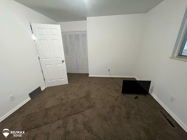 2906 Nathan Ave, Flint, MI 48506 - unfurnished bedroom with dark colored carpet, a closet, and baseboards