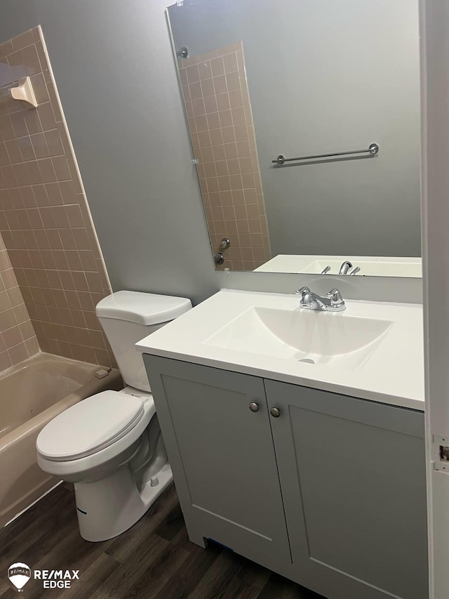 2906 Nathan Ave, Flint, MI 48506 - full bath featuring wood finished floors, vanity, shower / bathtub combination, and toilet
