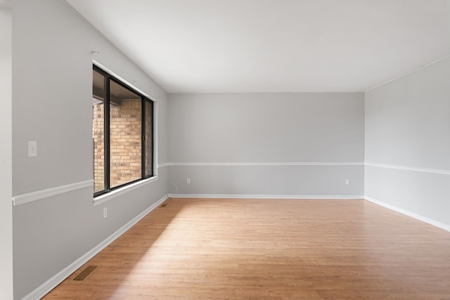 empty room featuring light wood-style flooring and baseboards