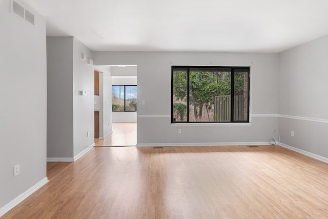 spare room with light wood finished floors and baseboards
