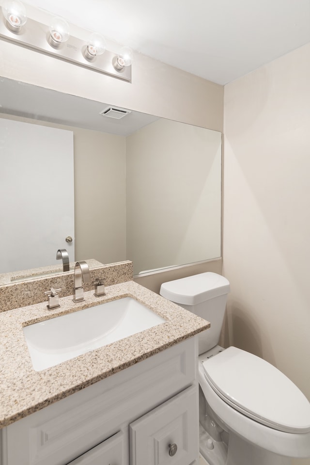 half bath with vanity and toilet