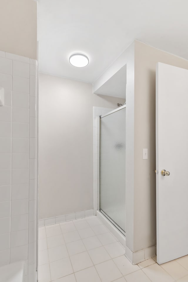 bathroom featuring a shower with shower door and tile patterned floors