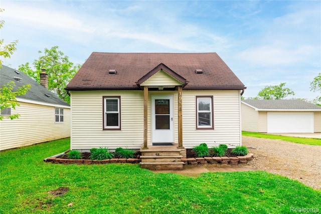 1953 Elmhurst St, Canton, MI 48187 - view of front of house with entry steps, a front lawn, driveway, and an outbuilding