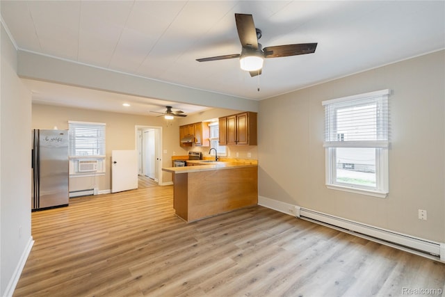 1953 Elmhurst St, Canton, MI 48187 - kitchen featuring appliances with stainless steel finishes, baseboard heating, a peninsula, a ceiling fan, and crown molding