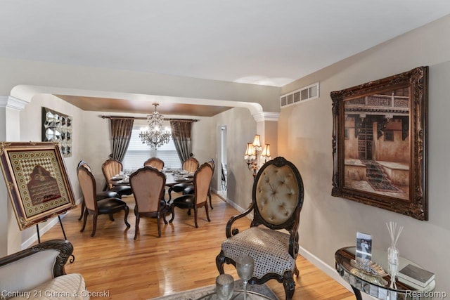26155 Timber Trl, Dearborn Heights, MI 48127 - dining room featuring a chandelier, light wood-style floors, and baseboards