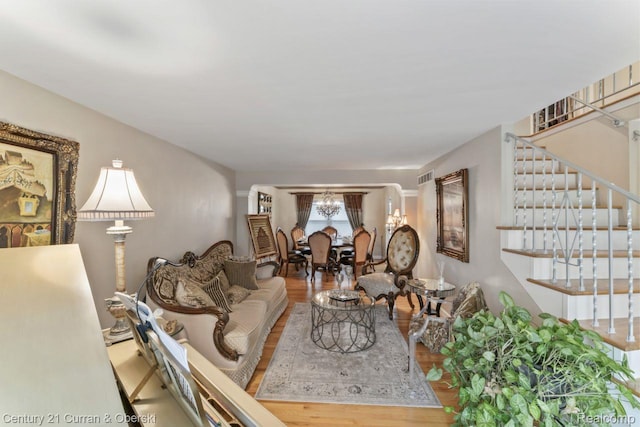 26155 Timber Trl, Dearborn Heights, MI 48127 - living area featuring wood finished floors, stairway, and a chandelier