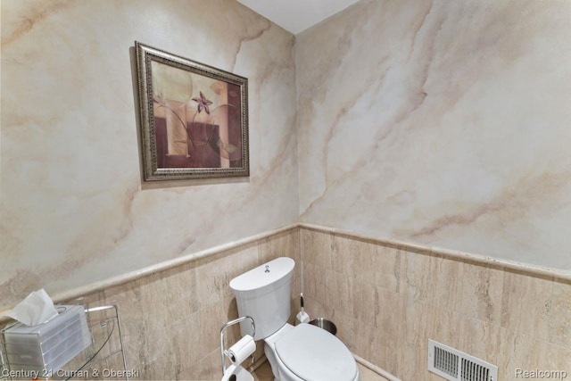 26155 Timber Trl, Dearborn Heights, MI 48127 - bathroom with toilet, tile walls, and a wainscoted wall