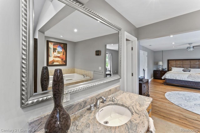 26155 Timber Trl, Dearborn Heights, MI 48127 - ensuite bathroom featuring wood finished floors, recessed lighting, vanity, and a tub to relax in