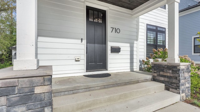property entrance featuring covered porch